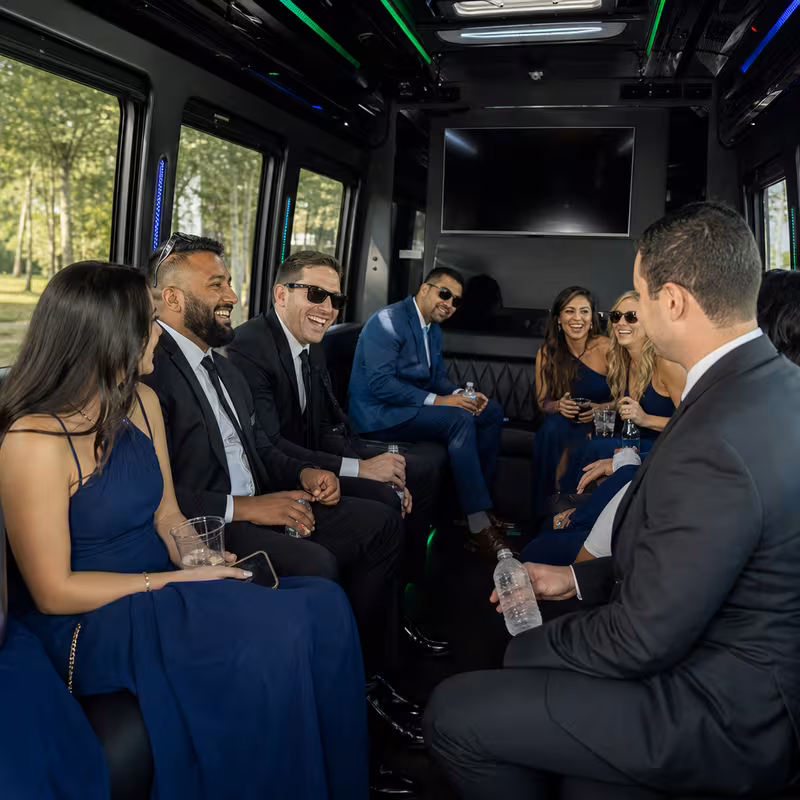 Wedding guests seated inside a Parkland party bus