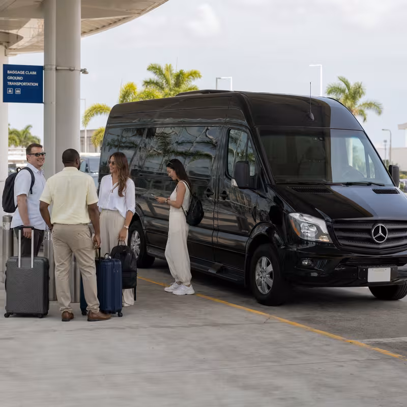 Group boarding a white charter bus for Airport Transportation transportation in Parkland