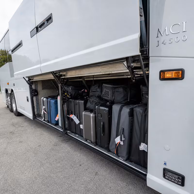 Party bus interior with wraparound leather seating and LED lighting in Parkland
