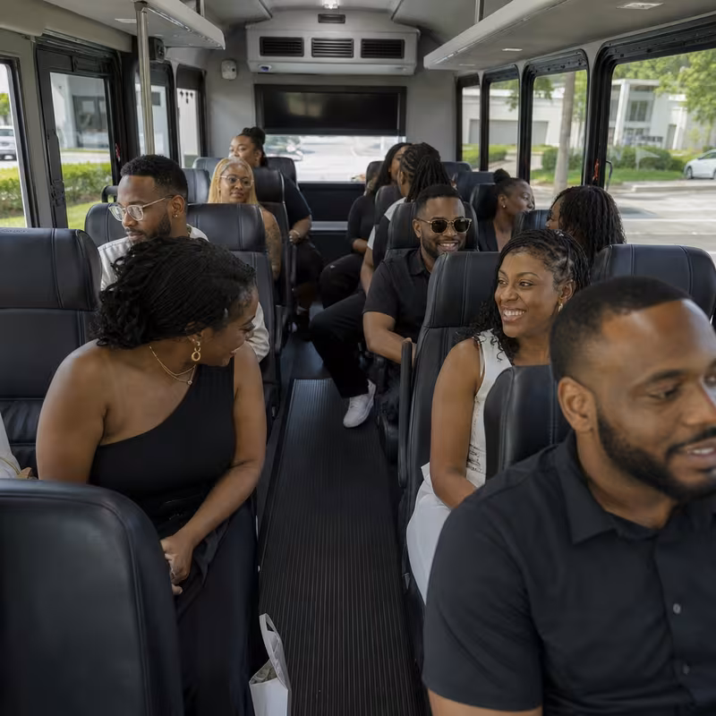 Group boarding a white charter bus for Private Event Transportation transportation in Parkland