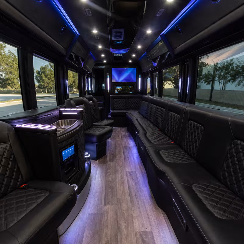 Party bus interior with wraparound leather seating and LED lighting in Parkland