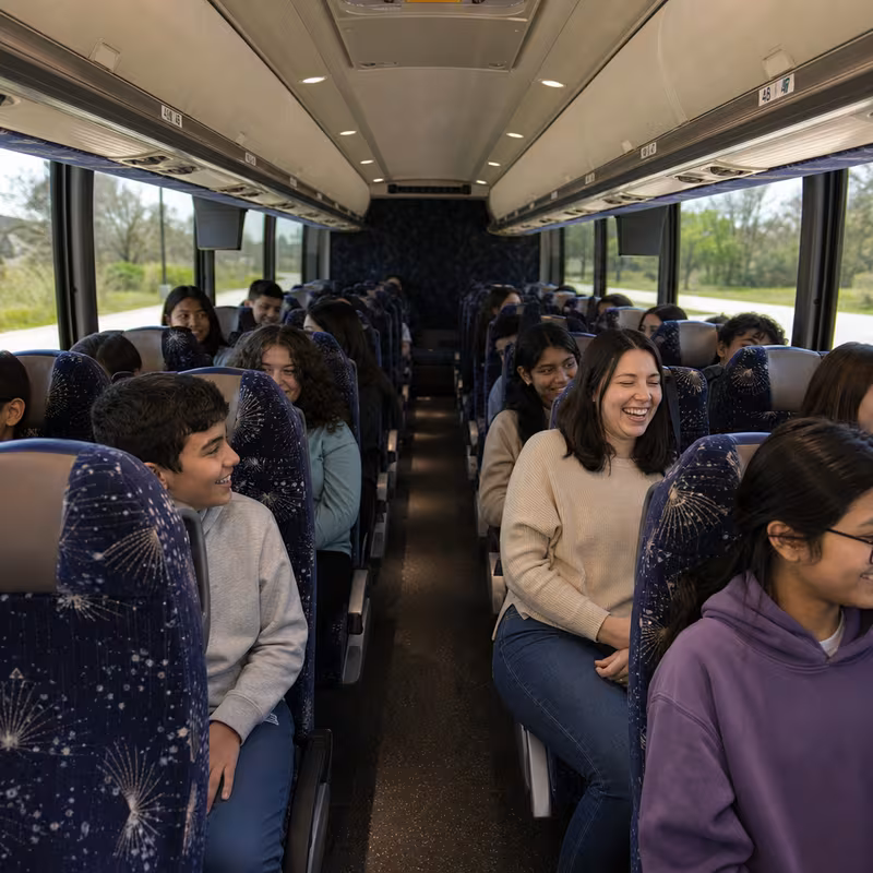 Group boarding a white charter bus for School Transportation transportation in Parkland